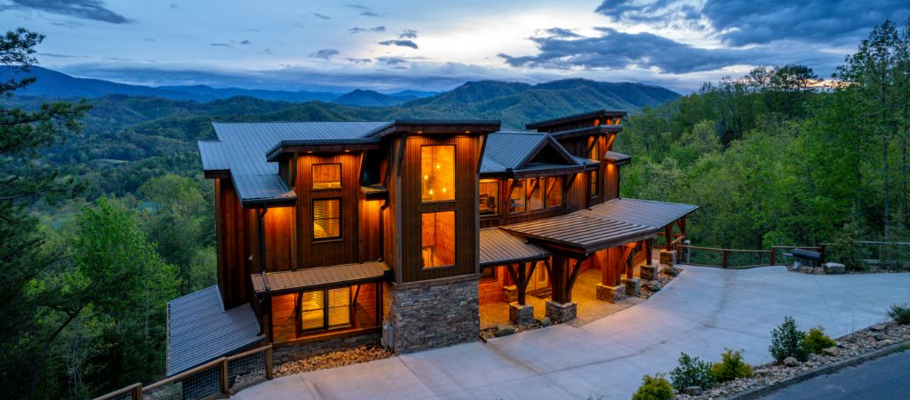 Luxury Smoky Mountain Cabin at Twilight A large luxury cabin in the Smokies with rolling mountains in the background at twilight.